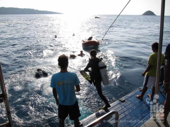 Drift divers doing a negative entry off the dive platform on their PADI Drift Diver Course