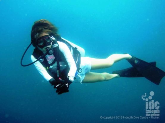 PADI Drift Diver Course student diver gently gliding along with the current next to her PADI Instructor