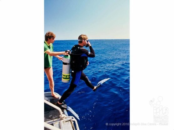 A PADI EanX Nitrox Course student doing a giant stride entry