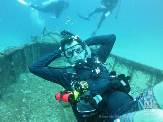 Happy diver laying in his hammock on the wreck