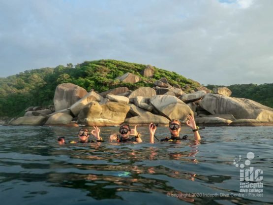 Turtle Rock on the surface with happy divers- Similan islands Dive Site